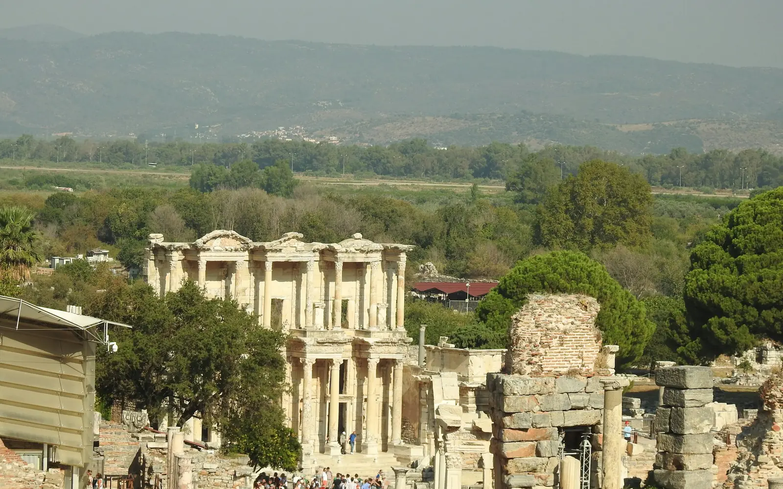 Visitors walking down Curetes Street towards the Library of Celsus at midday