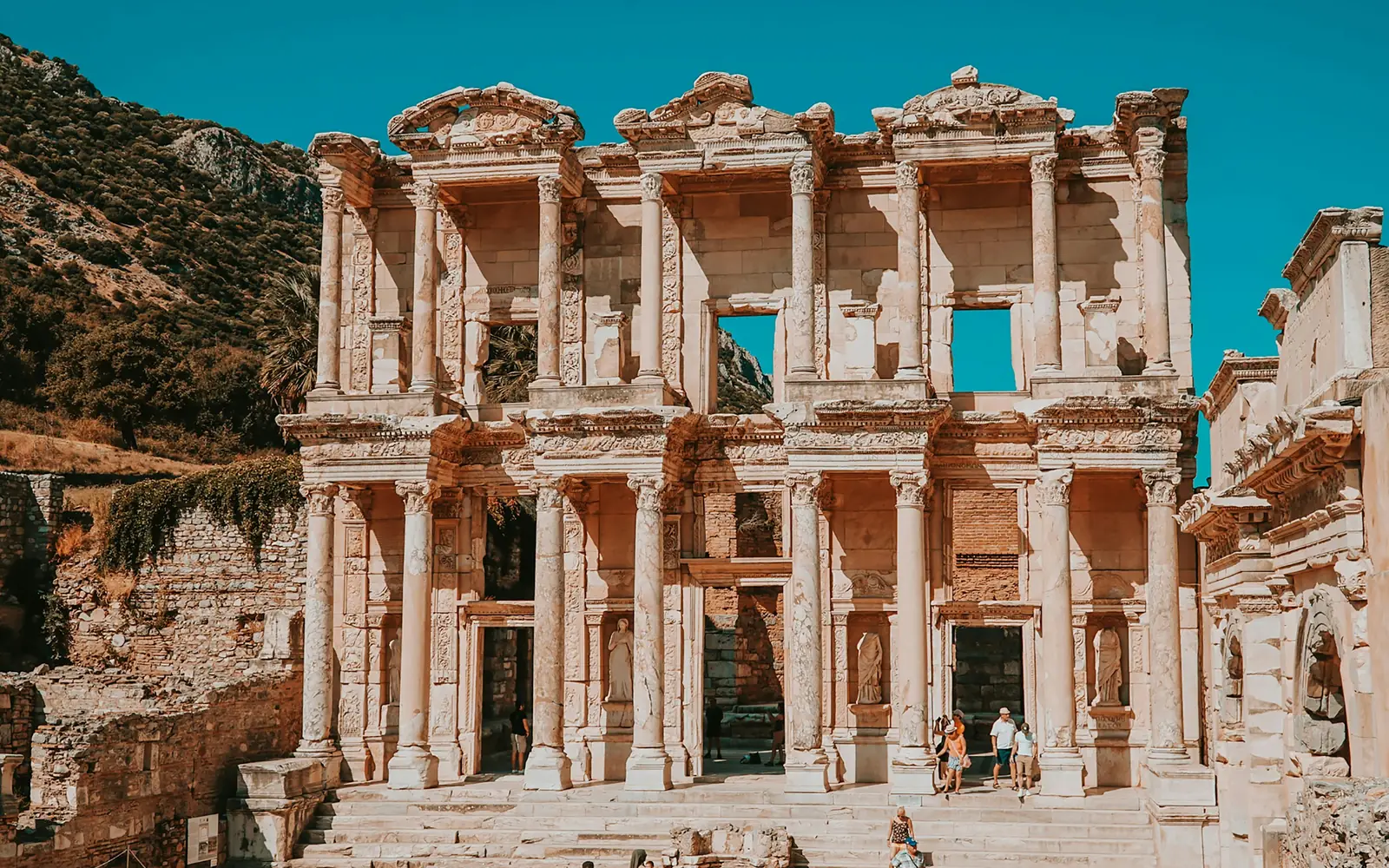 The two-storey marble facade of the Library of Celsus at Ephesus against a blue sky